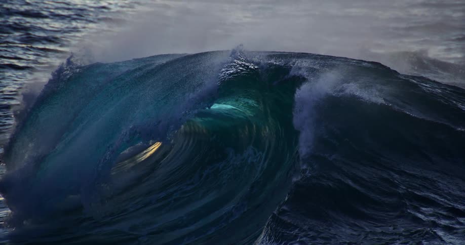 Wave forming in the sea and breaking splashing water and foam