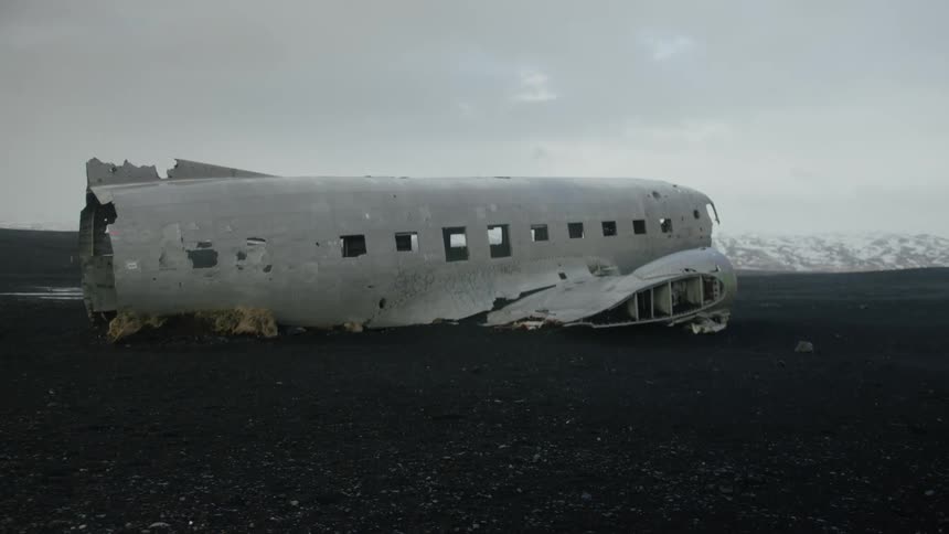A crashed airplane is abandoned on the field