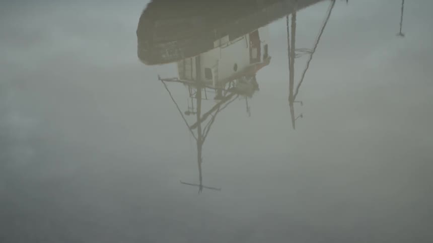 A large ship is reflected in the water