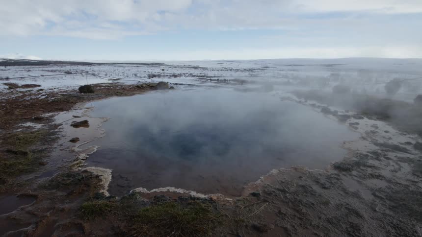 Steam rises from the hot springs