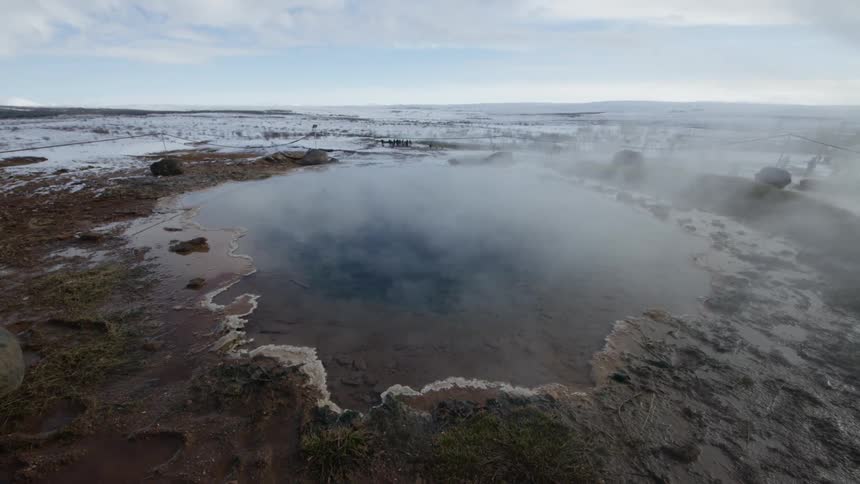Steam rises from the hot springs on the landscape