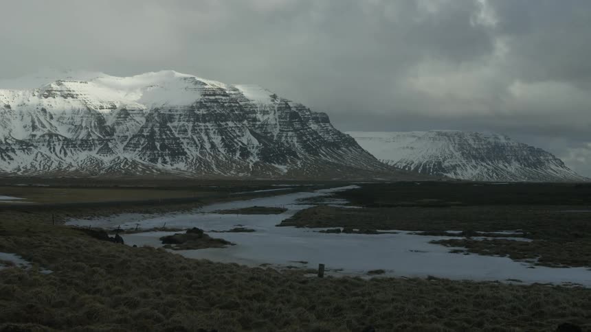 A small stream runs towards the mountains