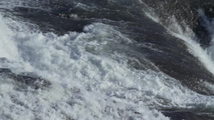 Strong river with flowing foam