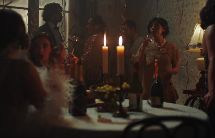 People in formal clothes with cocktails and wine at a party