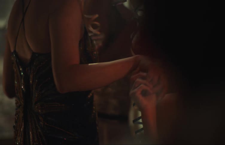Closeup of a womans hand shaking another womans hand in an indoor party setting