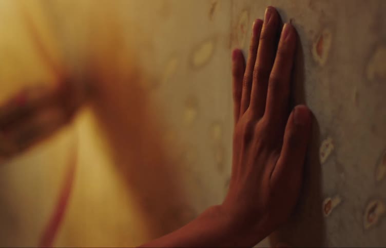 A womans hand hitting a wall