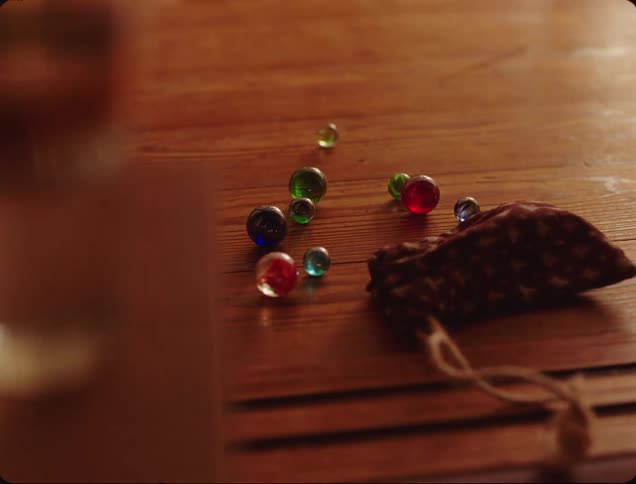 Collection of colorful marbles scattered on a wooden surface