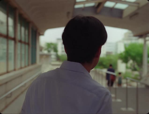 A man is searching for something in the city