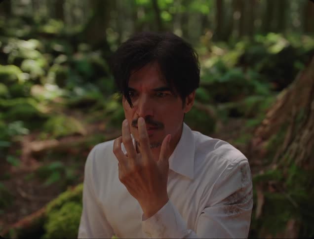 A man looks scared in the woods