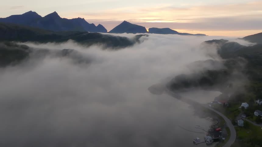 Fog is covering the river by the town