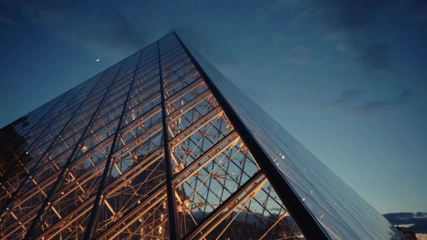 Closeup view of the louvre pyramid in paris at dusk