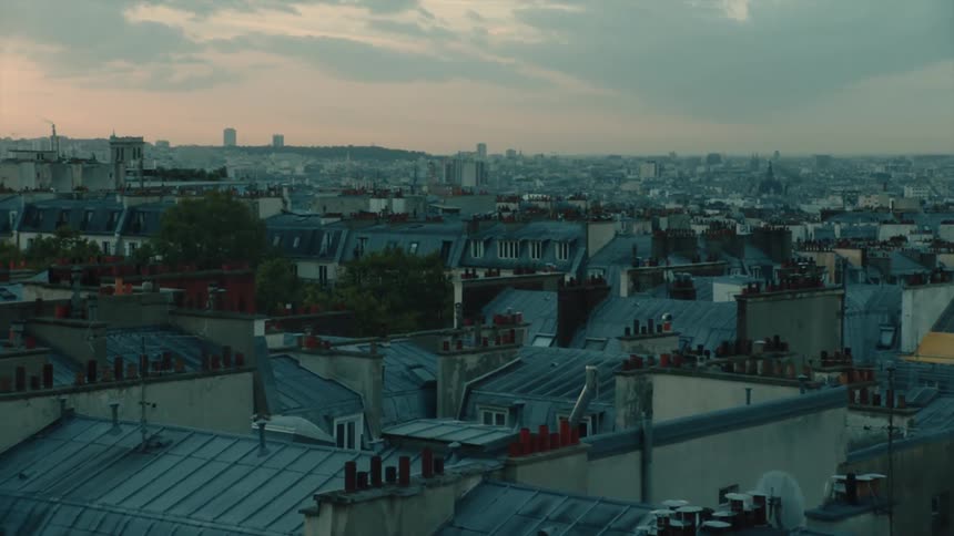 Sun tints the cloudy sky red over residential neighborhoods in the city in Paris