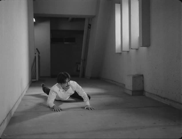 A man falls and slowly gets up in pain