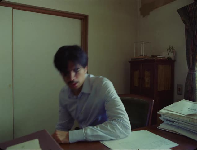 A father angrily closes a door on his young son and then sits and stews
