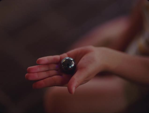 A person has a metal ball in their hand