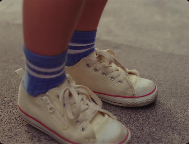 A childs feet moving back and forward in place