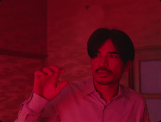 Man in inner space with red lights appearing and scaring him then the light begins to disappear and he smiles
