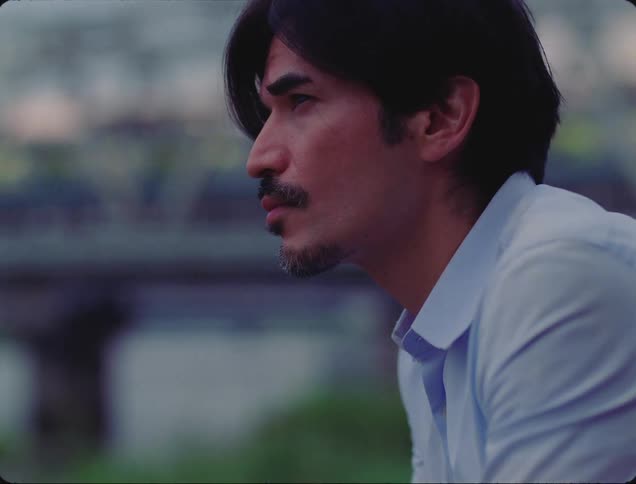 A man looks over at the traveling train