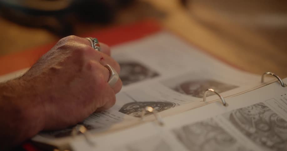 A man is pointing to things on the page