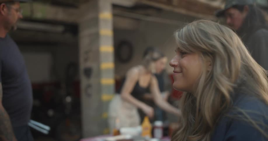 Friends grill outdoors near an open garage