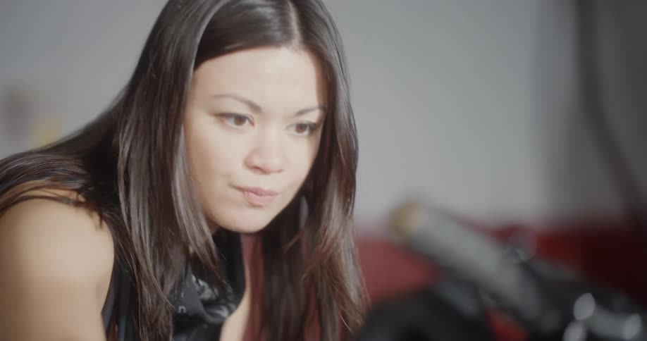 A woman is looking at a motorcycle