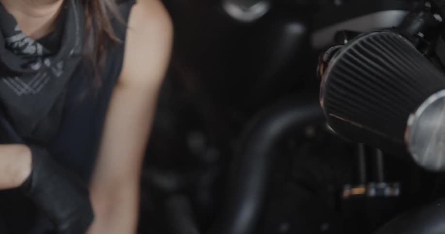 A woman is cleaning the motorcycle