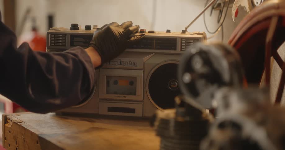 A person presses buttons on the radio
