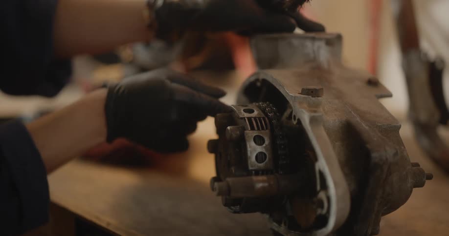 Woman uses a brush to give a piece of machinery a thorough cleaning