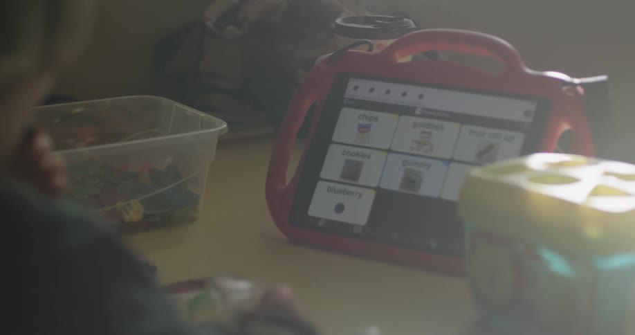 Child focused on an electronic toy that displays a screen