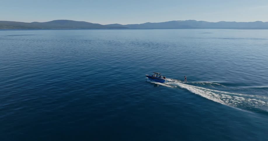 A boat is traveling on the lake water