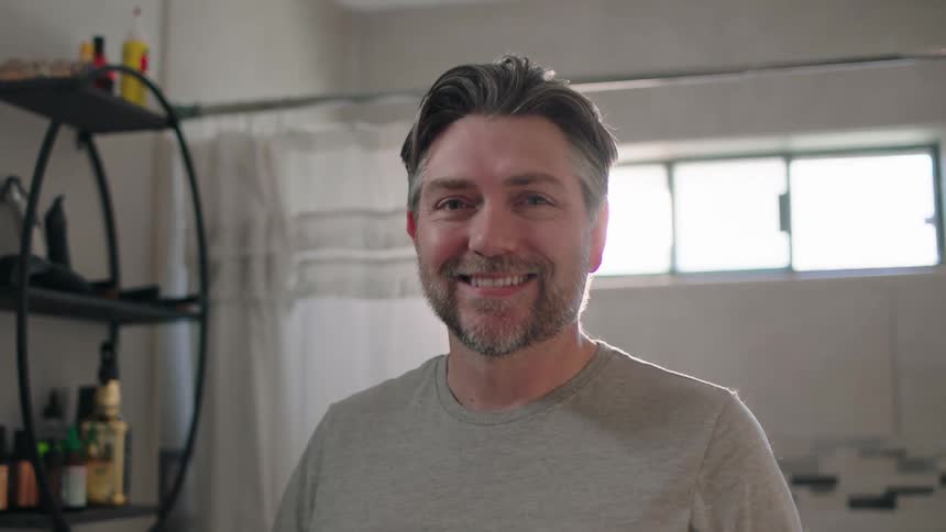 Portrait of a man giving a smile while in the bathroom