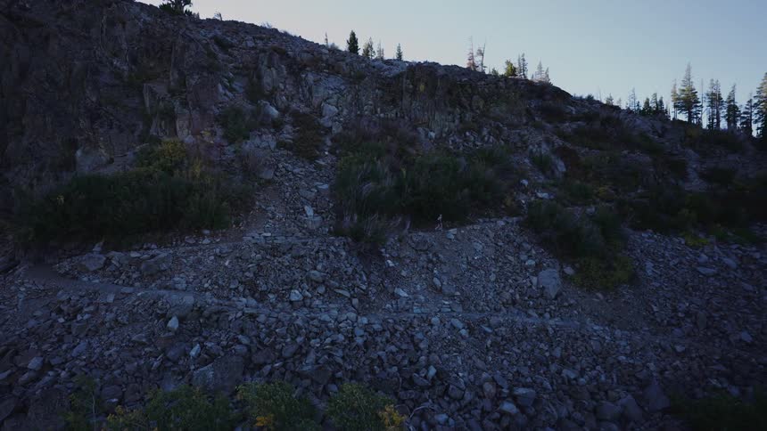 A jogger runs up a mountain trail on an early fall day