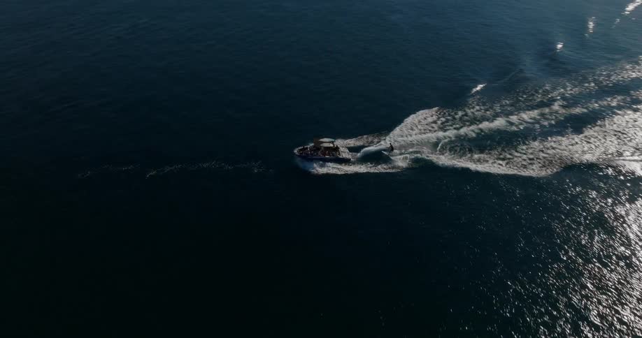 Person surfing on a lake being pulled by a boat