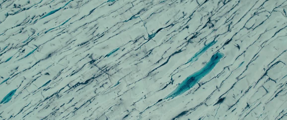 Aerial view of glaciers with crack patterns