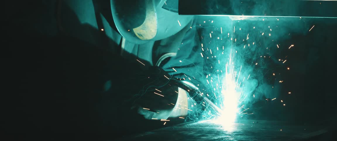 Person using a welding tool with sparks coming out