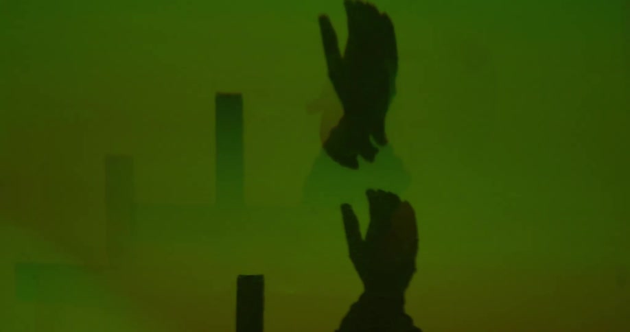 A person has their hand raised by the cross
