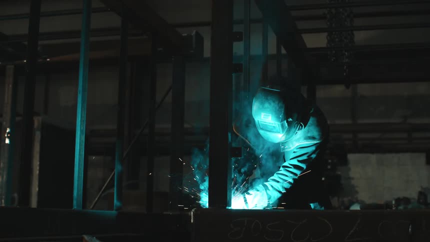 A man is welding in the warehouse