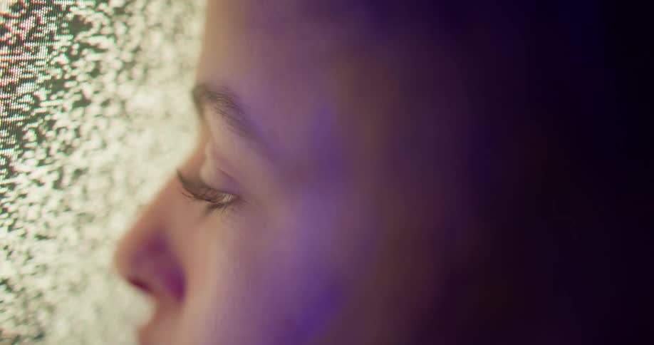 A woman is looking at the static on the screen