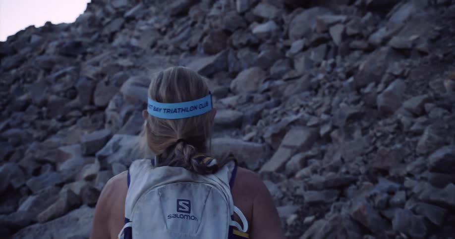 A woman runs up a steep rocky trail near Donner Pass