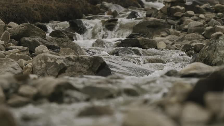 Water runs over the rocks in the small stream