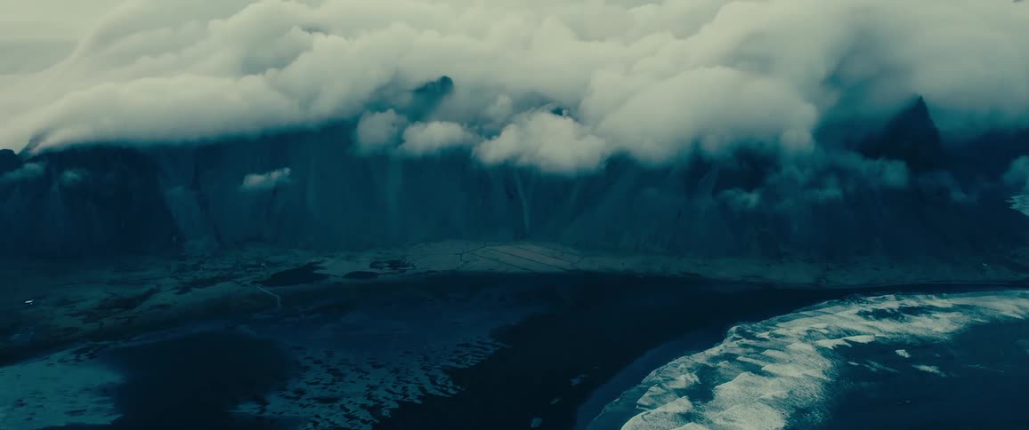A mountain range landscape shrouded in thick clouds
