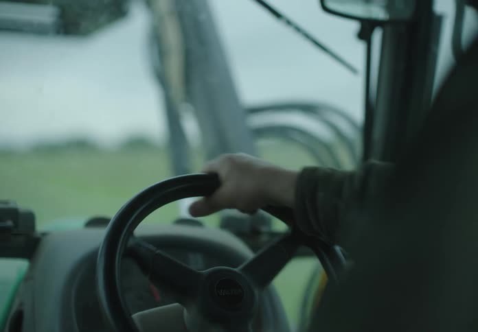 Hand of a person driving an agricultural machine