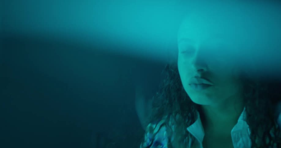 Portrait of a woman waking up scared in a dark room