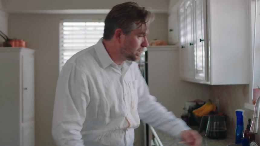 A man spills coffee all over his shirt