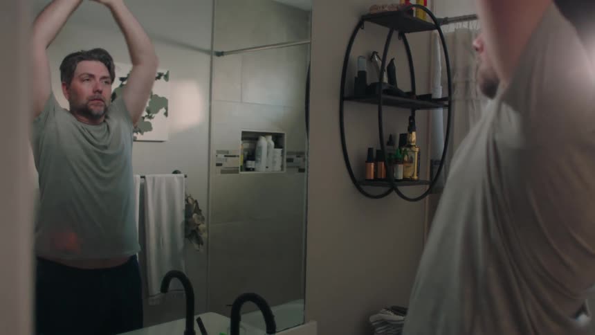 A man washes his face in the sink