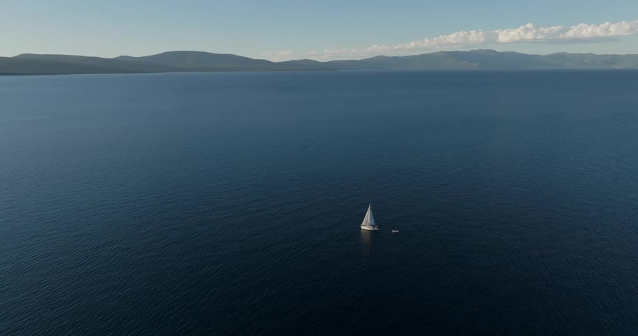 A sailboat cruises in the ocean