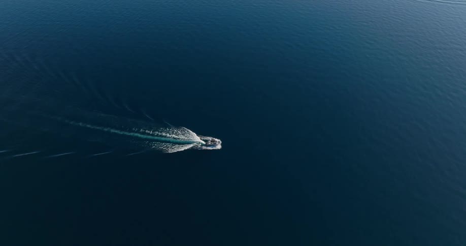 A boat leaves a wake as it moves through an ocean