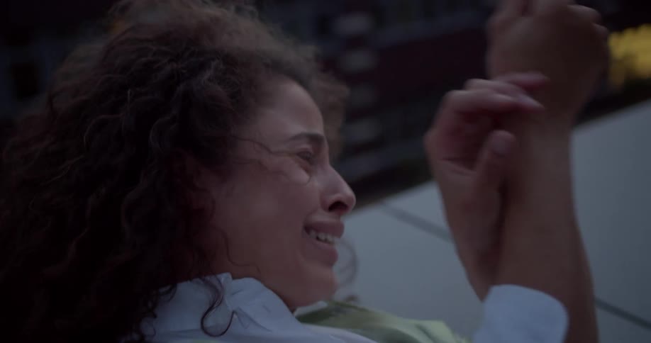 Portrait of a woman lying on the floor crying with her hand on her wrist in pain