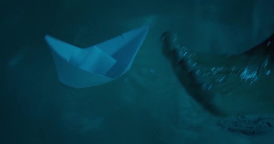 Paper boat floating in a tub of water