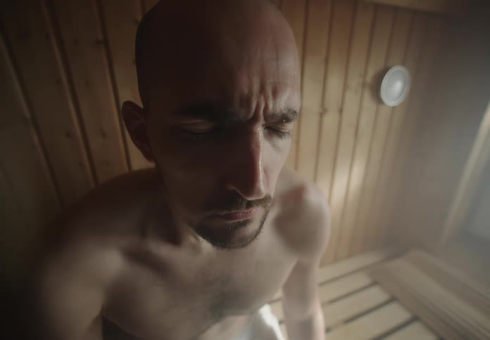 A man is sweating in the sauna